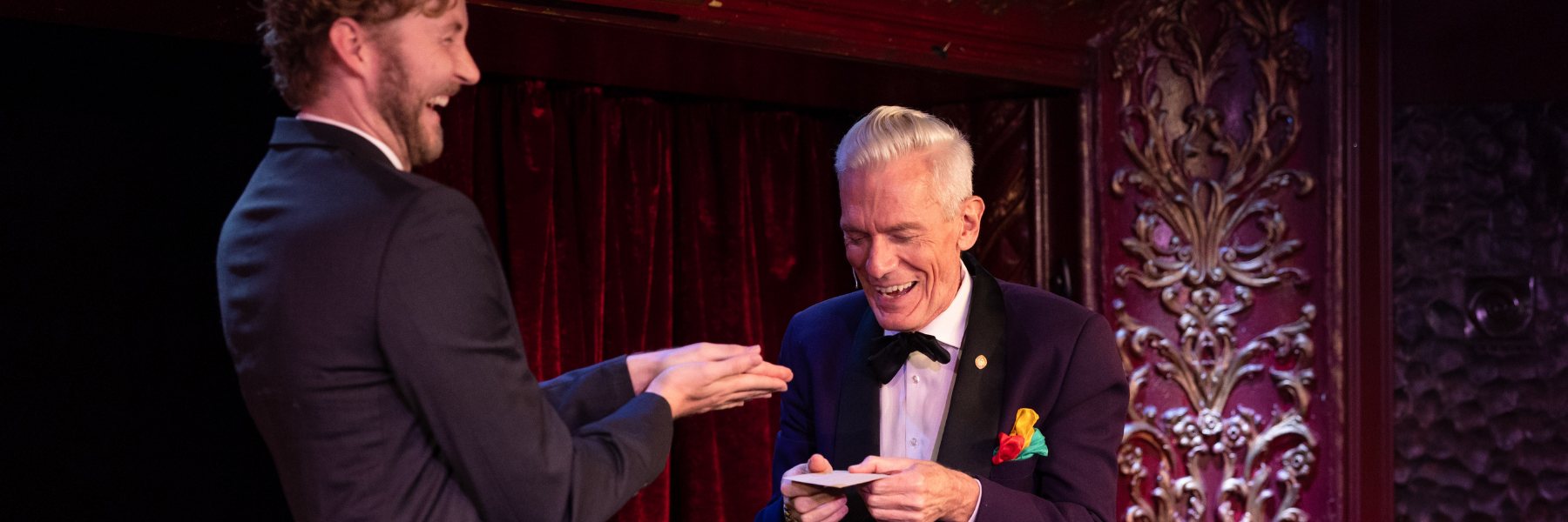 Felix Jones performing close-up magic for a laughing guest at a wedding