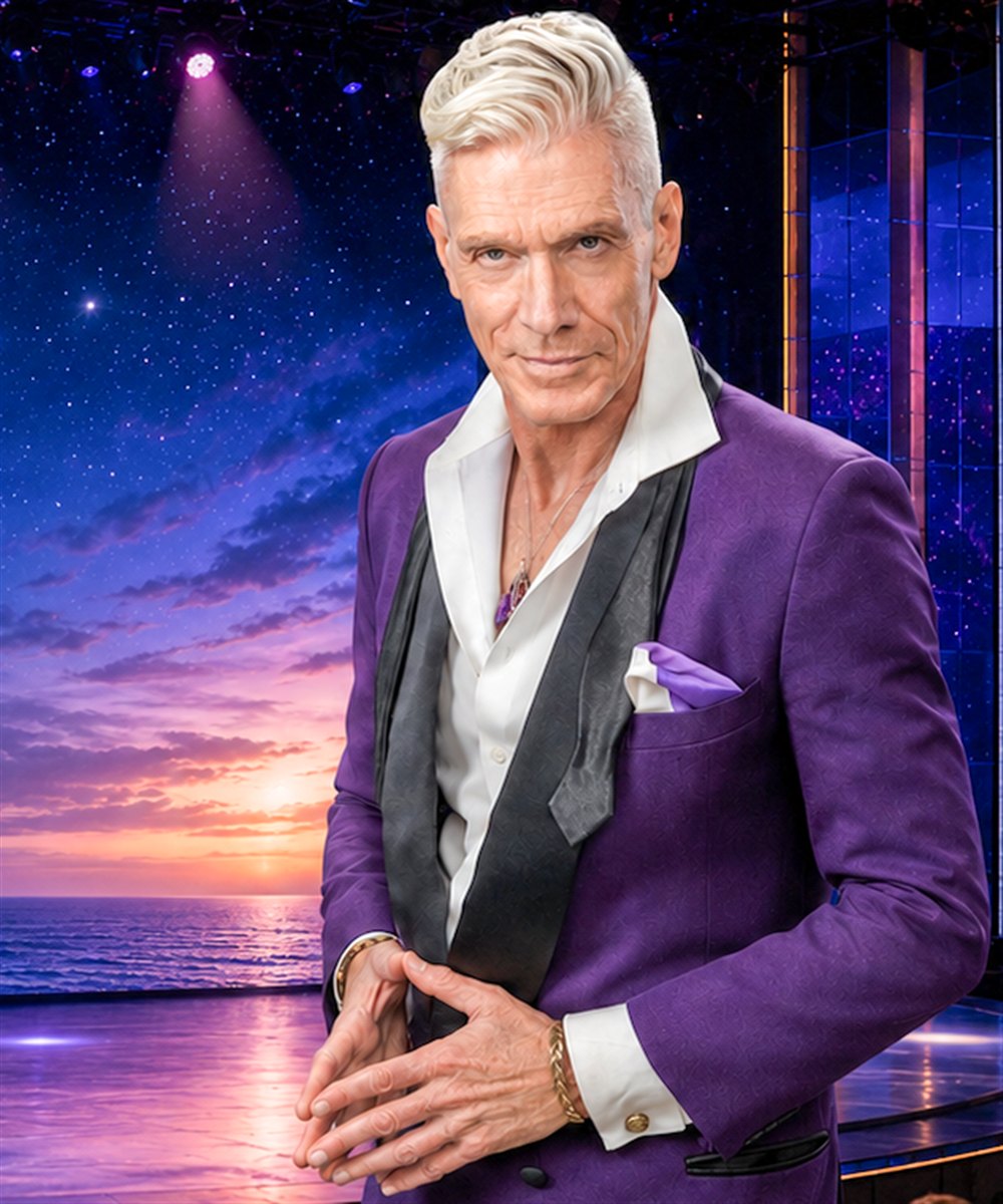 Felix Jones in a purple tuxedo jacket against a starry sunset stage backdrop